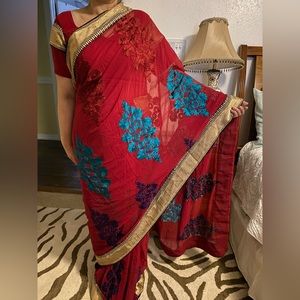 Red embroided saree with blouse and petticoat.